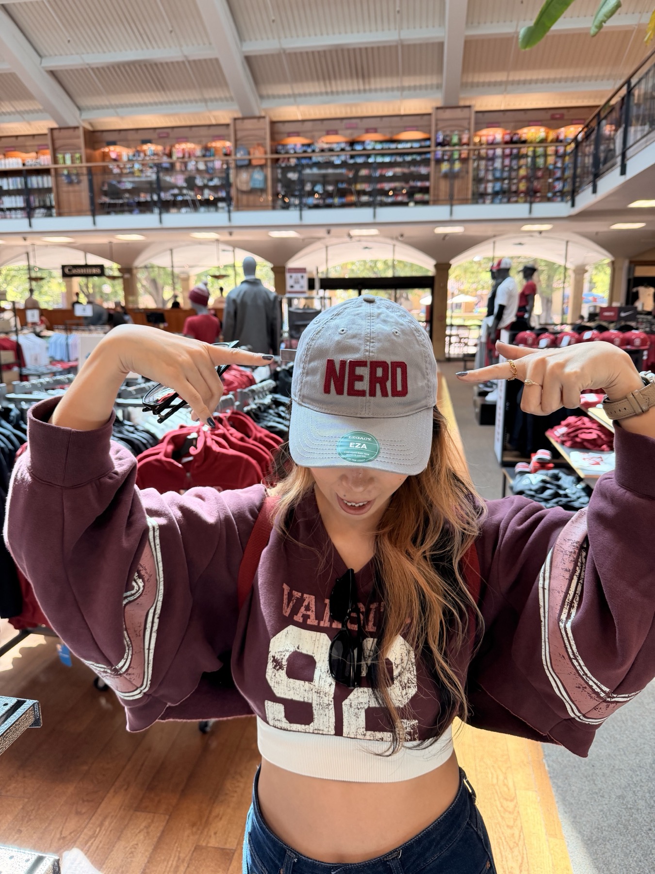 zzx pointing at a NERD cap in the Stanford shop